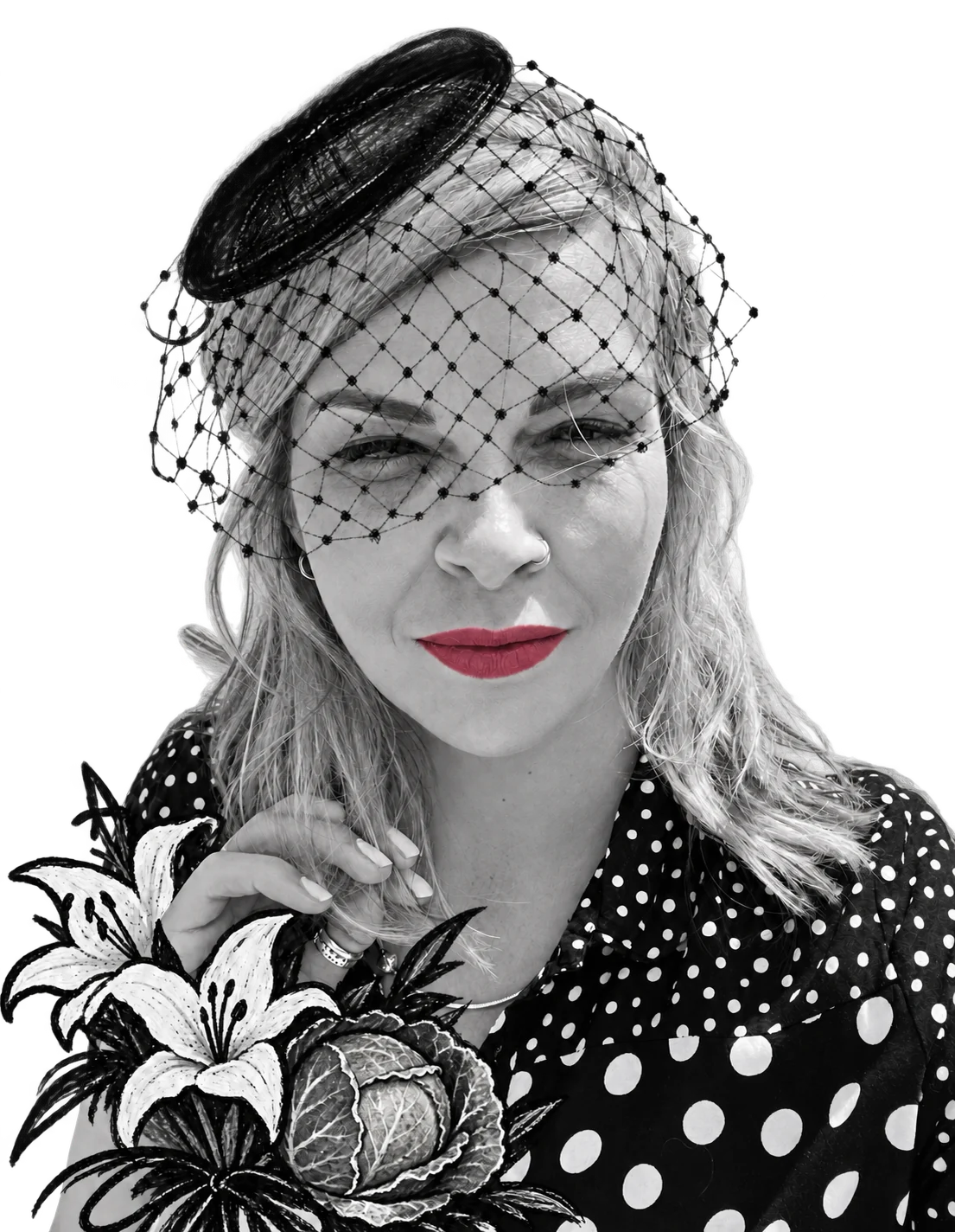 Jade Proudman, founder of Savage Cabbage, in a black veiled hat and red lipstick, holding white lilies and a cabbage